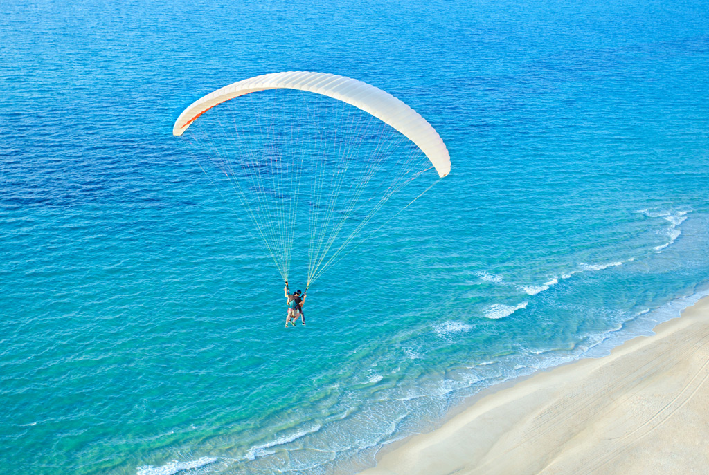 Photo: paraglider soaring over the sea